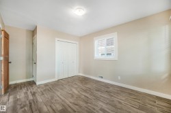 Wood-finish flooring, neutral wall tones, and white trim - 