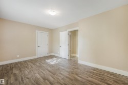 Neutral-toned walls complement the wood-finish flooring - 