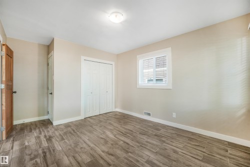 Wood-finish flooring, neutral wall tones, and white trim - 9347 105 Avenue Nw, Edmonton, AB 