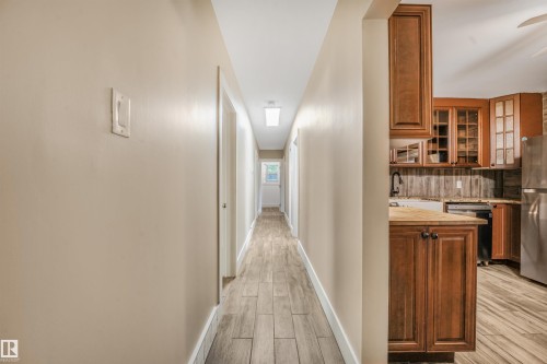 Hallway with wood-finish tile flooring - 9347 105 Avenue Nw, Edmonton, AB 