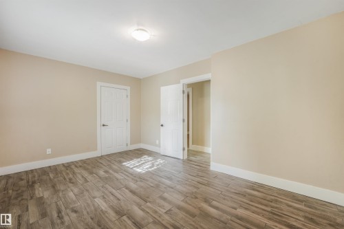 Neutral-toned walls complement the wood-finish flooring - 9347 105 Avenue Nw, Edmonton, AB 