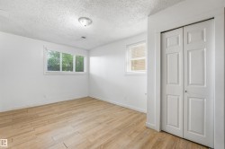 Wood-finish flooring, white walls, and a ceiling light fixture - 