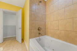 Subway tile shower surround with a jetted soaking tub and bronze fixtures - 