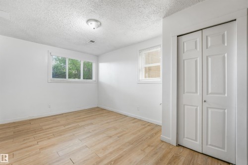 Wood-finish flooring, white walls, and a ceiling light fixture - 9347 105 Avenue Nw, Edmonton, AB 