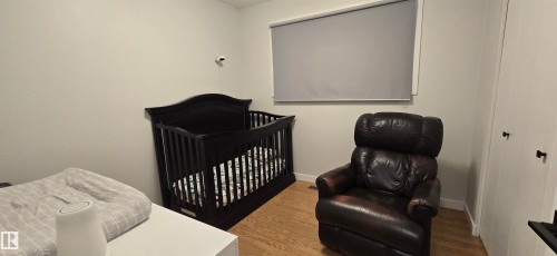 Wood-finish flooring with neutral wall tones and window roller shades - 4713 55 Avenue, Vegreville, AB 