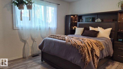 Light-toned walls with wood-finish flooring - 5201 56A Street, Beaumont, AB 