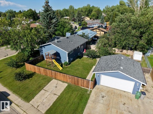 Blue exterior siding with a dark gray shingled roof - 5201 56A Street, Beaumont, AB 