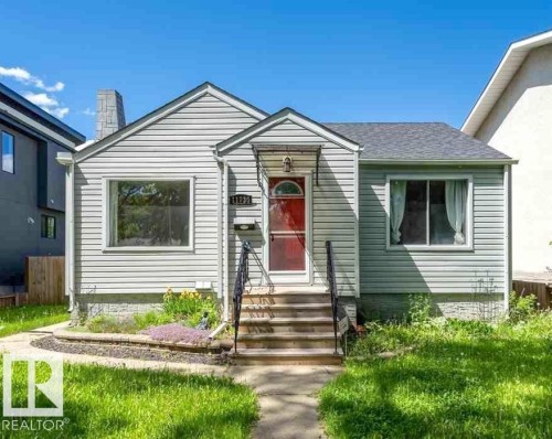 Siding exterior with a gabled roofline and a red entry door - 11730 125 Street Nw, Edmonton, AB 