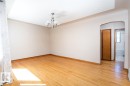 Hardwood flooring, chandelier lighting, arched doorway, and light-toned walls - 11730 125 Street Nw, Edmonton, AB 