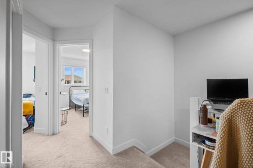 Neutral-toned carpeting, white walls, and a white ceiling create a bright interior - 4023 Hawthorn Link Link Sw, Edmonton, AB 