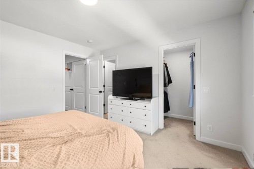 Carpeted flooring, white interior walls, recessed lighting, and a closet with bifold doors - 4023 Hawthorn Link Link Sw, Edmonton, AB 