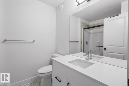 Vanity with integrated rectangular sink, chrome single-lever faucet, and black hardware - 4023 Hawthorn Link Link Sw, Edmonton, AB 