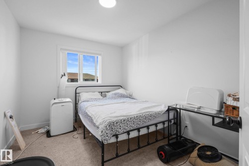 Recessed lighting, neutral wall paint, window with white trim, and carpet flooring - 4023 Hawthorn Link Link Sw, Edmonton, AB 