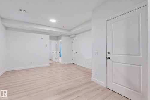 Recessed lighting, wood-finish flooring, white paneled doors, and painted white walls - 4023 Hawthorn Link Link Sw, Edmonton, AB 