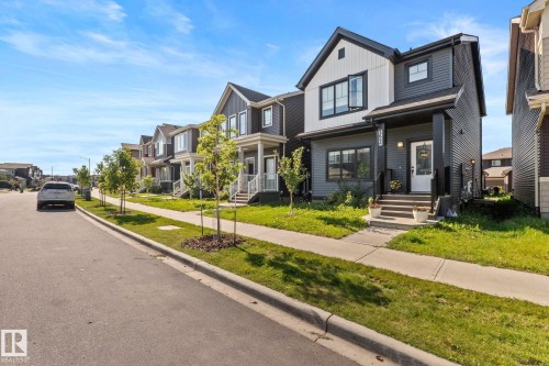 Contemporary two-story exterior with dark siding and white accents - 4023 Hawthorn Link Link Sw, Edmonton, AB 