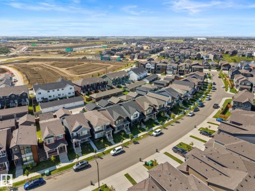 Residential street with multiple properties featuring varying architectural styles and attached garages - 4023 Hawthorn Link Link Sw, Edmonton, AB 