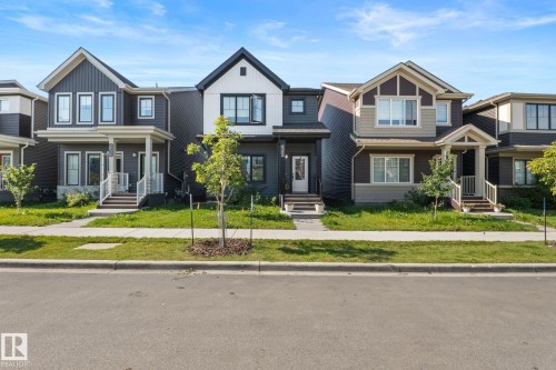Contemporary exterior with a covered porch, gabled roofline, and contrasting siding - 4023 Hawthorn Link Link Sw, Edmonton, AB 