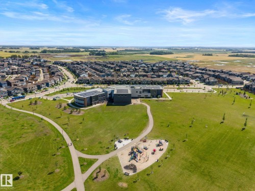 Expansive neighborhood featuring a large green space, paved walking paths, and a visible playground area - 4023 Hawthorn Link Link Sw, Edmonton, AB 