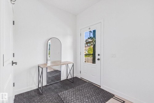 White entryway door with a paneled glass insert - 4023 Hawthorn Link Link Sw, Edmonton, AB 