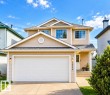 Two-story residence with neutral-toned siding, attached double-door garage, and a concrete driveway - 3236 27 Avenue Nw, Edmonton, AB 