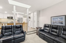 Sunken living room with plush carpet flooring - 