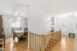 Hardwood-finish flooring extends through the entry and dining space - 