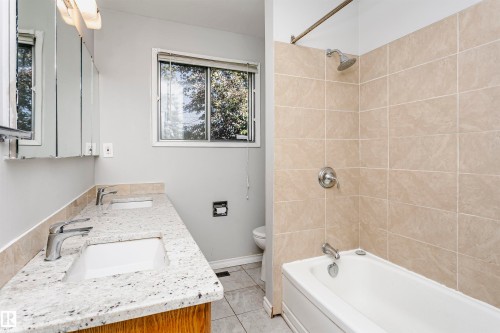 Double vanity with integrated sinks and a speckled countertop - 11440 44A Avenue Nw, Edmonton, AB 