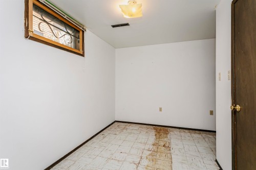 Window with security bars and wood frame - 11440 44A Avenue Nw, Edmonton, AB 