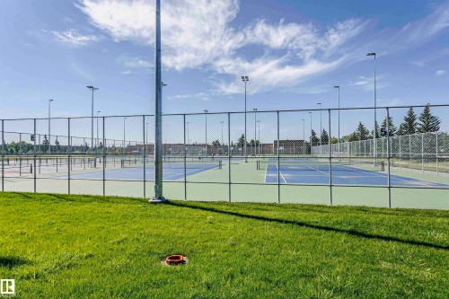 Multiple hard-surface tennis courts featuring perimeter fencing and overhead lighting - 11440 44A Avenue Nw, Edmonton, AB 