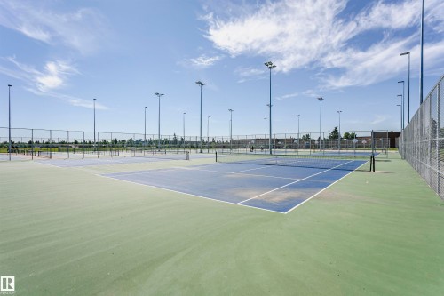 Multiple outdoor tennis courts with chain-link fencing, surrounded by tall light poles - 11440 44A Avenue Nw, Edmonton, AB 