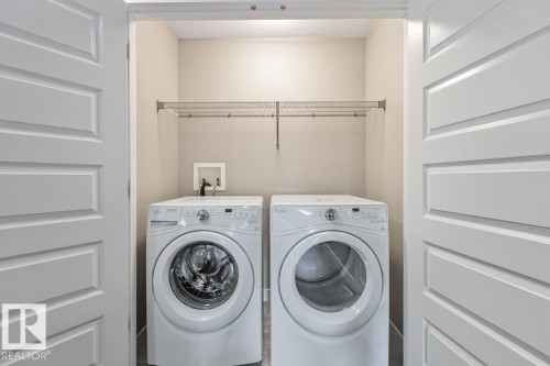 Dedicated laundry area featuring a wire shelving unit and panel doors - 22 Hope Common, Spruce Grove, AB 