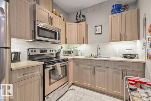 Wood-finish cabinetry paired with light-toned countertops - 22 Hope Common, Spruce Grove, AB 