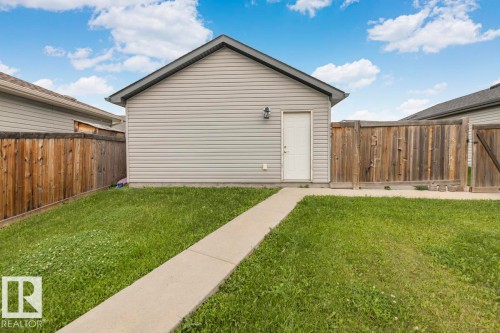 Detached structure with horizontal siding, a gabled roof, and an exterior light fixture - 22 Hope Common, Spruce Grove, AB 
