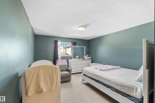 Recessed ceiling light fixture, neutral wall color, and carpeted flooring - 13028 34 Street Nw, Edmonton, AB 