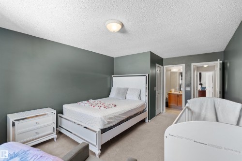 Carpeted flooring with painted walls and a flush-mount ceiling light - 13028 34 Street Nw, Edmonton, AB 