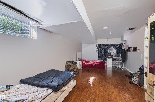 Recessed window well, wood-finish flooring, and white walls - 13028 34 Street Nw, Edmonton, AB 