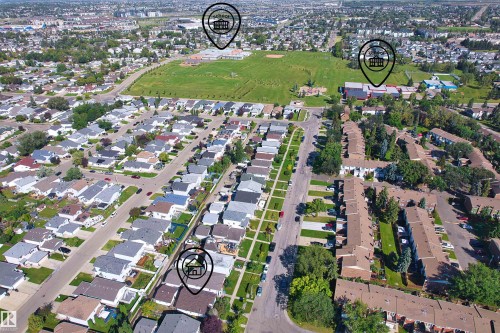 Aerial perspective showcasing an established neighborhood with detached residences and multi-unit buildings - 13028 34 Street Nw, Edmonton, AB 