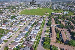Aerial perspective showcasing an established neighborhood with detached residences and multi-unit buildings - 
