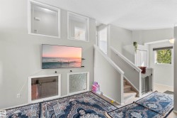 Carpeted staircase with white railing - 