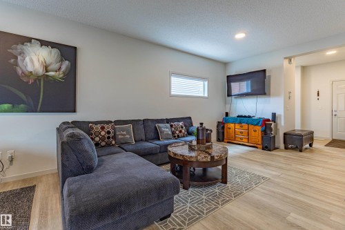 Spacious living area featuring light wood-finish flooring and recessed lighting - 41 Sequoia Bend, Fort Saskatchewan, AB 