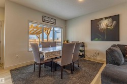 Dining area featuring wood-finish flooring and a large window - 