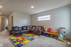 Carpeted interior space featuring light-colored walls and a horizontal window with blinds - 