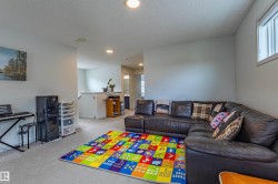 Bright living area featuring recessed lighting and carpet flooring - 