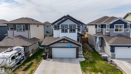 Contemporary two-story residence featuring a white and black exterior with vertical and horizontal siding - 41 Sequoia Bend, Fort Saskatchewan, AB 