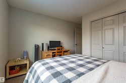Carpeted interior room featuring light-colored walls and a textured ceiling - 