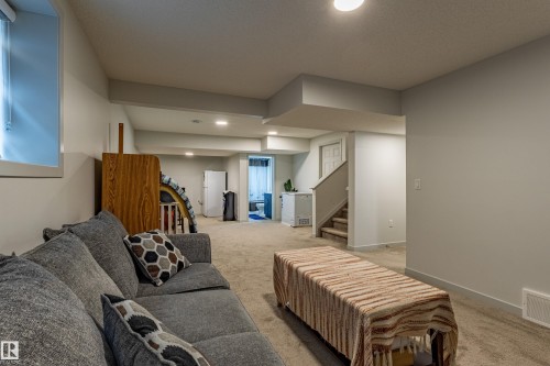 Lower level featuring neutral carpeting, recessed lighting, painted walls, and a visible window - 41 Sequoia Bend, Fort Saskatchewan, AB 