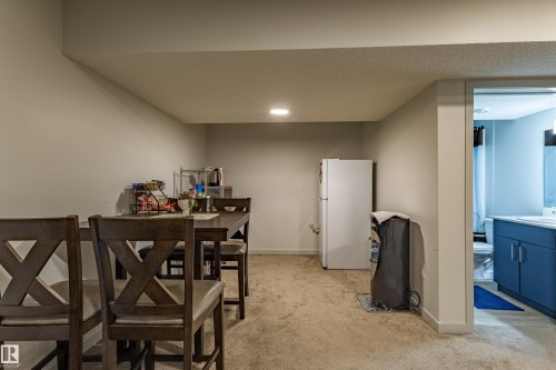 Spacious room with light-toned walls and neutral carpeting, featuring a recessed ceiling light - 41 Sequoia Bend, Fort Saskatchewan, AB 