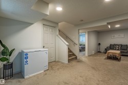 Finished lower level with carpet flooring and recessed lighting - 