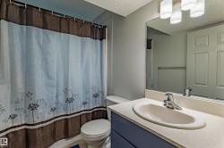 Bathroom featuring a vanity with an integrated sink, a speckled countertop, and a full-width mirror - 
