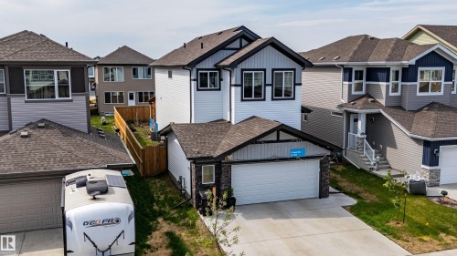 Contemporary two-story home featuring a combination of light and dark siding with black trim accents - 41 Sequoia Bend, Fort Saskatchewan, AB 
